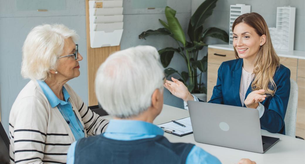 Senior couple consulting with female advisor